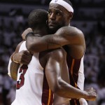 Miami Heat's LeBron James hugs Dwyane Wade during the second half of Game 1 of the NBA Finals basketball game against the Dallas Mavericks, Tuesday, May 31, 2011, in Miami. The Heat defeated the Mavericks 92-84. (AP Photo/Lynne Sladky)