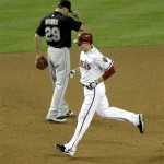 Arizona Diamondbacks' Kelly Johnson rounds third after hitting a solo home run as Florida Marlins' Greg Dobbs (29) looks away during the eighth inning of a baseball game against the Tuesday, May 31, 2011, in Phoenix. (AP Photo/Matt York)