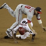 Arizona Diamondbacks' Justin Upton (10) is forced out as he up-ends Washington Nationals' Danny Espinosa during the fourth inning of a baseball game, Thursday, June 2, 2011, in Phoenix. (AP Photo/Matt York)