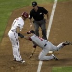 Arizona Diamondbacks' Gerardo Parra, left, is tagged out by Washington Nationals' Jerry Hairston on a fielders choice during the third inning of a baseball game, Thursday, June 2, 2011, in Phoenix. Looking on is umpire Rob Drake. (AP Photo/Matt York)