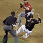 Washington Nationals shortstop Ian Desmond, top, makes the catch from catcher Wilson Ramos in order to tag out Arizona Diamondbacks' Kelly Johsnon, right, as umpire Rob Drake, left, looks on on a steal attempt in the sixth inning of an MLB baseball game Saturday, June 4, 2011, in Phoenix. (AP Photo/Paul Connors)