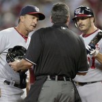 Washington Nationals manager Jim Riggleman, left, and pitcher Jason Marquis, right, question home plate umpire Rob Drake, center, about his call of a strike after Marquis was hit by a pitch from Arizona Diamondbacks pitcher Ian Kennedy in the second inning of an MLB baseball game on Sunday, June 5, 2011, in Phoenix. (AP Photo/Paul Connors)