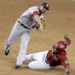 Washington Nationals second baseman Danny Espinosa, left, throws to first after forcing out Arizona Diamondbacks' Juan Miranda, right, but cannot complete the double play in the ninth inning of an MLB baseball game on Sunday, June 5, 2011, in Phoenix. (AP Photo/Paul Connors)

