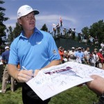 Ernie Els, of South Afirca, signs autographs between the 15th and 16th holes during practice before the U.S. Open Championship golf tournament in Bethesda, Md., Wednesday, June 15, 2011. (AP Photo/Nick Wass