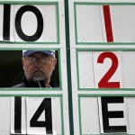Scorekeeper Clint Siemens looks through the scoreboard along the second hole during the first round of the U.S. Open Championship golf tournament in Bethesda, Md., Thursday, June 16, 2011. (AP Photo/Mike Groll)
