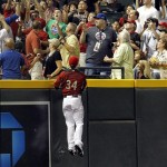USA left fielder Bryce Harper watches a fan catch a home run hit by World team's Alfredo Silverio during the sixth inning of the All Star Futures baseball game Sunday, July 10, 2011, in Phoenix. (AP Photo/Ross D. Franklin)