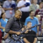 Former New York Yankee Bernie Williams performs the National Anthem prior to the All-Star Futures baseball game between the U.S team and World team, Sunday, July 10, 2011, in Phoenix. (AP Photo/Matt York)