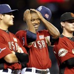 From left, U.S. players Matt Moore, Tim Beckham, and Gary Brown look on during player introductions prior to the All-Star Futures baseball game, Sunday, July 10, 2011, in Phoenix. (AP Photo/Ross D. Franklin)