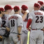 Arizona Diamondbacks manager Kirk Gibson (23) confers with players on the mound in the seventh inning of Game 1 of baseball's National League division series against the Milwaukee Brewers, Saturday, Oct. 1, 2011, in Milwaukee. (AP Photo/The Arizona Republic, Rob Schumacher)