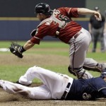 Arizona Diamondbacks catcher Miguel Montero can't catch the throw as Milwaukee Brewers' Jerry Hairston Jr. scores from third on a squeeze bunt by Jonathan Lucroy during the sixth inning of Game 2 of baseball's National League division series Sunday, Oct. 2, 2011, in Milwaukee. (AP Photo/David J. Phillip)
