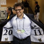 Milwaukee Brewers owner Mark Attanasio shows off the lining in his suit before Game 2 of baseball's National League division series against the Arizona Diamondbacks Sunday, Oct. 2, 2011, in Milwaukee. The Brewers won the game 9-4 to take a 2-0 lead in the series. (AP Photo/Jeffrey Phelps)