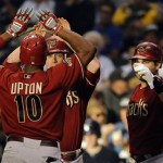 Arizona Diamondbacks' Justin Upton is congratulated by teammates after his two-run home run in the fifth inning against the Milwaukee Brewers in Game 2 of the National League division series, Sunday, Oct. 2, 2011, in Milwaukee. (AP Photo/The Journal, Times, Scott Anderson)