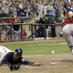 Arizona Diamondbacks catcher Miguel Montero can't catch the throw as Milwaukee Brewers' Jerry Hairston Jr. scores from third on a squeeze bunt by Jonathan Lucroy during the sixth inning of Game 2 of baseball's National League division series Sunday, Oct. 2, 2011, in Milwaukee. (AP Photo/David J. Phillip)
