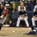 Arizona Diamondbacks catcher Miguel Montero can't catch the throw as Milwaukee Brewers' Jerry Hairston Jr. scores from third on a squeeze bunt by Jonathan Lucroy during the sixth inning of Game 2 of baseball's National League division series Sunday, Oct. 2, 2011, in Milwaukee. (AP Photo/Jeffrey Phelps)