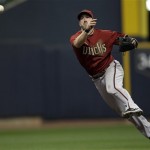 Arizona Diamondbacks' Willie Bloomquist throws out Milwaukee Brewers' Rickie Weeks during the sixth inning of Game 2 of baseball's National League division series Sunday, Oct. 2, 2011, in Milwaukee. (AP Photo/David J. Phillip)
