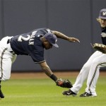 Milwaukee Brewers' Nyjer Morgan (2) and Corey Hart (1) can't come up with a double by Arizona Diamondbacks' Chris Young during the sixth inning of Game 2 of baseball's National League division series Sunday, Oct. 2, 2011, in Milwaukee. (AP Photo/David J. Phillip)
