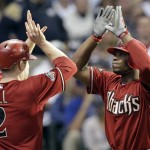 Arizona Diamondbacks' Justin Upton is congratulated at home by Aaron Hill (2) after Upton hit a two-run home run during the fifth inning of Game 2 of baseball's National League division series against the Milwaukee Brewers Sunday, Oct. 2, 2011, in Milwaukee. (AP Photo/David J. Phillip)
