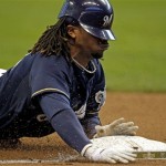 Milwaukee Brewers' Rickie Weeks slides safely into third for an RBI triple during the third inning of Game 2 of baseball's National League division series against the Arizona Diamondbacks Sunday, Oct. 2, 2011, in Milwaukee. (AP Photo/Jeffrey Phelps)