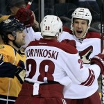 Phoenix Coyotes left wing Taylor Pyatt, right, celebrates with Lauri Korpikoski (28), of Finland, after Pyatt scored against the Nashville Predators in the first period of an NHL hockey game on Tuesday, Dec. 6, 2011, in Nashville, Tenn. At left is Nashville Predators defenseman Jack Hillen (38). (AP Photo/Mark Humphrey)