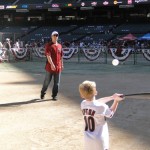 Willie Bloomquist pitches batting practice to a youngster with a good-
looking left-handed swing at Subway FanFest. (Photo by Vince 
Marotta/Arizona Sports)