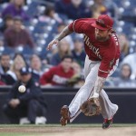 Arizona Diamondbacks third baseman Ryan Roberts charges a slow roller hit by San Diego Padres' Chase Headley in the fifth inning of a baseball game on Wednesday, April 11, 2012, in San Diego. Roberts got the out on a close play at first. (AP Photo/Lenny Ignelzi)