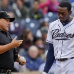San Diego Padres' Cameron Maybin, right, pleads his case with umpire Eric Cooper after striking out to end the third inning in a baseball game against the Arizona Diamondbacks,Wednesday, April 11, 2012, in San Diego. (AP Photo/Lenny Ignelzi)