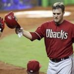 Arizona Diamondbacks' Wade Miley is greeted at the dugout after scoring on a single by Gerardo Parra in the third inning during a baseball game against the Miami Marlins in Miami, Sunday, April 29, 2012. (AP Photo/Lynne Sladky)