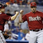 Arizona Diamondbacks catcher Miguel Montero (26) and relief pitcher Bryan Shaw, right, celebrate their 8-4 victory over the Miami Marlins at a baseball game in Miami, Sunday, April 29, 2012. (AP Photo/Lynne Sladky)