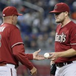 Arizona Diamondbacks starting pitcher Wade Miley, right, hands the ball to manager Kirk Gibson (23) as he is relieved in the seventh inning during a baseball game against the Miami Marlins in Miami, Sunday, April 29, 2012. The Diamondbacks defeated the Marlins 8-4. (AP Photo/Lynne Sladky)
