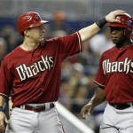 Arizona Diamondbacks' Willie Bloomquist, left, greets Justin Upton, right, after they scored on a double hit by Jason Kubel in the sixth inning during a baseball game against the Miami Marlins in Miami, Sunday, April 29, 2012. The Diamondbacks defeated the Marlins 8-4. (AP Photo/Lynne Sladky)