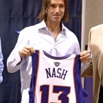 Newly acquired Phoenix Suns guard Steve Nash, right, holds his new jersey Wednesday, July 14, 2004, in Phoenix. Nash, who was originally signed by the Suns in 1996, returns to Phoenix after spending six seasons in Dallas. (AP Photo/Matt York)
