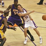 Los Angeles Lakers' Lamar Odom, left, and Kwame Brown, rear, defend as Phoenix Suns guard Steve Nash dishes off during their NBA first-round playoff basketball game Sunday, April 23, 2006, at U.S. Airways Center in Phoenix. The Suns won 107-102 to go up 1-0 in the best-of-seven series behind Nash's 20 points and 10 assists. (AP Photo/Rick Hossman)