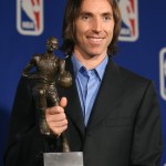 Phoenix Suns guard Steve Nash, of Canada, clutches the Maurice Podoloff Trophy for the NBA's Most Valuable Player for the 2005-06 season during an award ceremony Sunday, May 7, 2006, in Phoenix. Nash won the award for the second year in a row Sunday, becoming just the ninth player in league history to do so. (AP Photo/Paul Connors)