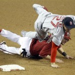 St. Louis Cardinals second baseman Tyler 
Greene, top, tumbles over Arizona Diamondbacks' 
Willie Bloomquist, bottom, as the Cardinals 
turn a double play on a ball hit by 
Diamondbacks' Justin Upton in the fifth inning 
of a baseball game on Wednesday, May 9, 2012, 
in Phoenix. (AP Photo/Paul Connors)