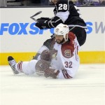 Phoenix Coyotes defenseman Michal Rozsival of 
the Czech Republic, below, falls as Los Angeles 
Kings center Jarret Stoll looks during the 
first period of Game 3 of the NHL hockey 
Stanley Cup Western Conference finals, 
Thursday, May 17, 2012, in Los Angeles. (AP 
Photo/Mark J. Terrill)