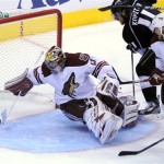 Phoenix Coyotes goalie Mike Smith, left, 
deflects a shot as Los Angeles Kings center 
Anze Kopitar, center, of Slovenia and 
defenseman Derek Morris during the third period 
of Game 3 of the NHL hockey Stanley Cup Western 
Conference finals, Thursday, May 17, 2012, in 
Los Angeles. The Kings won 2-1. (AP Photo/Mark 
J. Terrill)