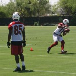 Larry Fitzgerald catches a pass as Early Doucet 
watches. (Craig Grialou/Arizona Sports)