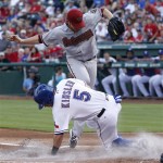 Texas Rangers' Ian Kinsler (5) slides safe into home plate against Arizona Diamondbacks starting pitcher Ian Kennedy (31), scoring on a wild pitch during the first inning of a baseball game, Tuesday, June 12, 2012, in Arlington, Texas. (AP Photo/LM Otero)
