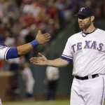 Texas Rangers starting pitcher Colby Lewis, right, celebrates with catcher Yorvit Torrealba after the final out of a baseball game against the Arizona Diamondbacks, Tuesday, June 12, 2012, in Arlington, Texas. Lewis pitched a four-hitter in the Rangers' 9-1 win. (AP Photo/LM Otero)