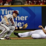 Arizona Diamondbacks' Aaron Hill tags 
Cincinnati Reds' Scott Rolen out at second 
base as he tries to steal in the eighth inning 
of a baseball game in Cincinnati, Tuesday, 
July 17, 2012. The Reds won 4-0. (AP Photo/Tom 
Uhlman)