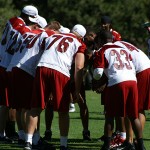 The Cardinals huddle up during the team's morning walk-through at 
training camp August 1. (Adam Green/Arizona Sports)