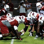 The Cardinals line up for a goal-line drill during the team's annual 
night practice at Lumberjack Stadium on August 1, 2012. (Adam 
Green/Arizona Sports)