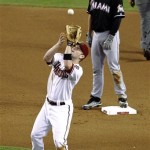 Arizona Diamondbacks' Aaron Hill catches a pop fly hit by Miami Marlins' Ricky Nolasco as Marlins' Rob Brantly stands on second during the fourth inning of a baseball game, Tuesday, Aug. 21, 2012, in Phoenix. (AP Photo/Matt York)