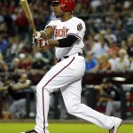 Arizona Diamondbacks' Justin Upton connects for a two-run single against the Miami Marlins during the first inning of a baseball game, Tuesday, Aug. 21, 2012, in Phoenix. (AP Photo/Matt York)