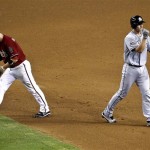 Miami Marlins' Rob Brantly, right, reacts to being caught off second and tagged out in a rundown, as Arizona Diamondbacks' John McDonald heads to the dugout during the fifth inning of a baseball game, the second game of a doubleheader, Wednesday, Aug. 22, 2012, in Phoenix. (AP Photo/Matt York)