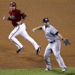 Arizona Diamondbacks' John McDonald watches as Miami Marlins' Donnie Murphy, right, throws out Wade Miley during the fourth inning of a baseball game, the second game of a doubleheader, Wednesday, Aug. 22, 2012, in Phoenix. (AP Photo/Matt York)