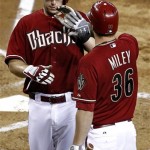 Arizona Diamondbacks' Paul Goldschmidt high-fives teammate Wade Miley (36) after scoring on a passed ball during the fourth inning of a baseball game against the Miami Marlins, the second game of a doubleheader, Wednesday, Aug. 22, 2012, in Phoenix. (AP Photo/Matt York)