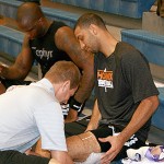 Kendall Marshall getting his thigh wrapped by assistant athletic trainer Tom Maystadt with Jermaine O'Neal in the background at training camp in San Diego. (Photo: Craig Grialou/Arizona Sports)
