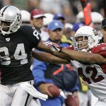 Oakland Raiders wide receiver Jerry Porter, left, is pushed out of bounds by Arizona Cardinals safety Terrence Holt during the first half. (AP Photo/Marcio Jose Sanchez)