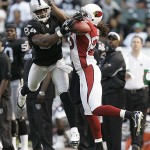 Arizona Cardinals corner back Eric Green, right, breaks up a pass intended for Oakland Raiders wide receiver Jerry Porter during the first half on an exhibition. (AP Photo/Marcio Jose Sanchez)